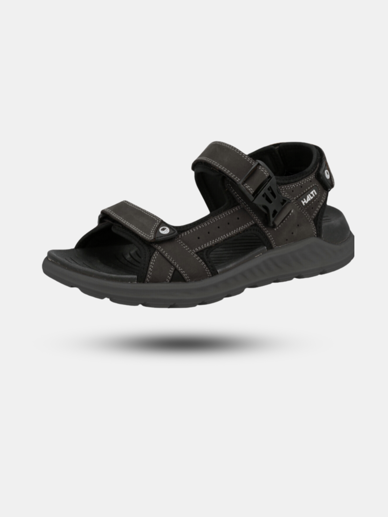 Halti Sora Sandaali on musta unisex-sandaali, jossa tarranauhat ja ergonominen pohjallinen.