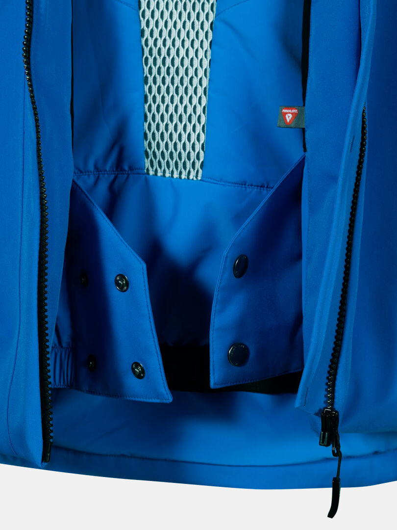 Halti Vertica DX Laskettelutakki Miesten lähikuvassa näkyy verkkovuori, Primaloft-täyte, musta vetoketju, nepparit ja punainen lappu.