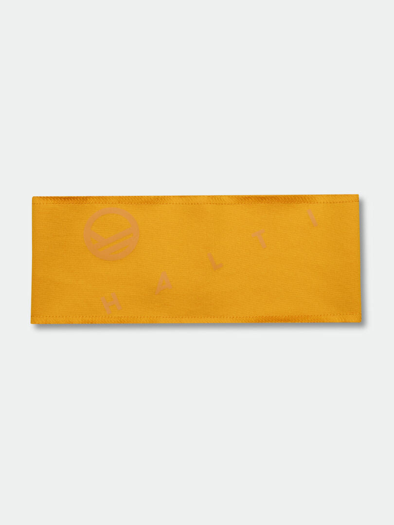 Halti Kara Panta on litteä, suorakaiteen muotoinen keltainen sporttinen panta, jossa on hillitty pinkki Halti-logo ja -printti.