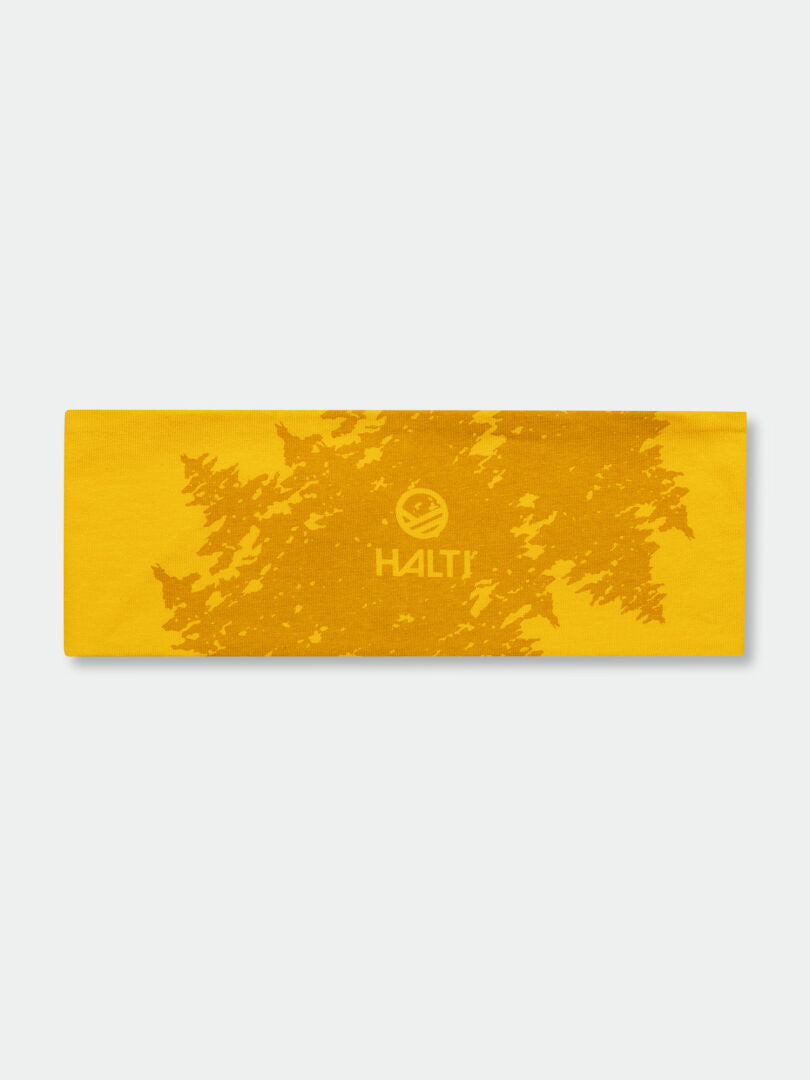 Halti Laava Panta on keltainen sporttinen pääpanta, jossa on lehtikuvio ja logo. Ihanteellinen ulkokäyttöön vaaleanharmaalla pohjalla.
