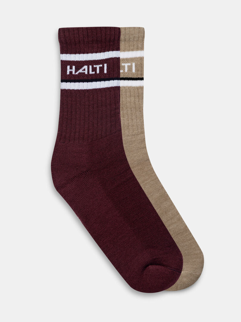 Halti Merinovillasukat, 2 paria: punaruskeat ja beiget sukat, joissa on valkoiset raidat ja HALTI yläosan lähellä.