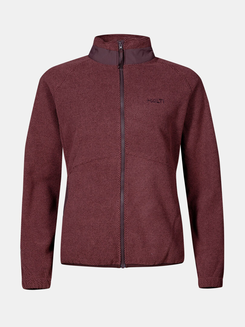 Halti Soolo Välitakki Naisten: ruskeankeltainen vetoketjullinen fleece, jossa on korkea kaulus ja hienovarainen kuviointi vaalealla pohjalla.