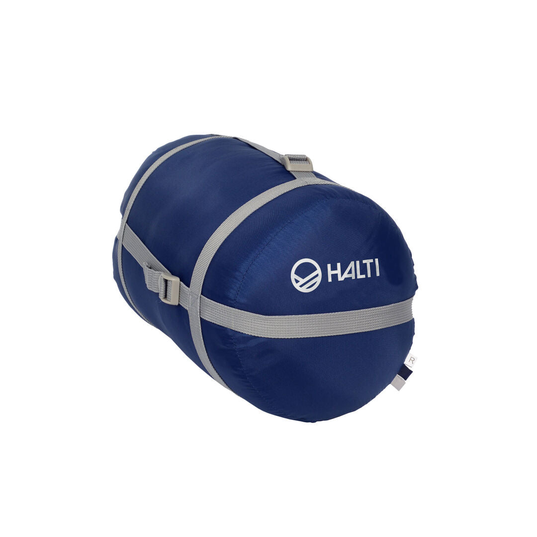 Sininen Wooly Makuupussi by Halti kompressiopussissa, jossa on harmaat hihnat ja Halti-logo sivulla.