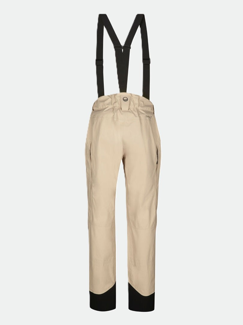 Halti Settler 3L DrymaxX naisten beige lasketteluhousut mustilla olkaimilla, valkoisella taustalla.