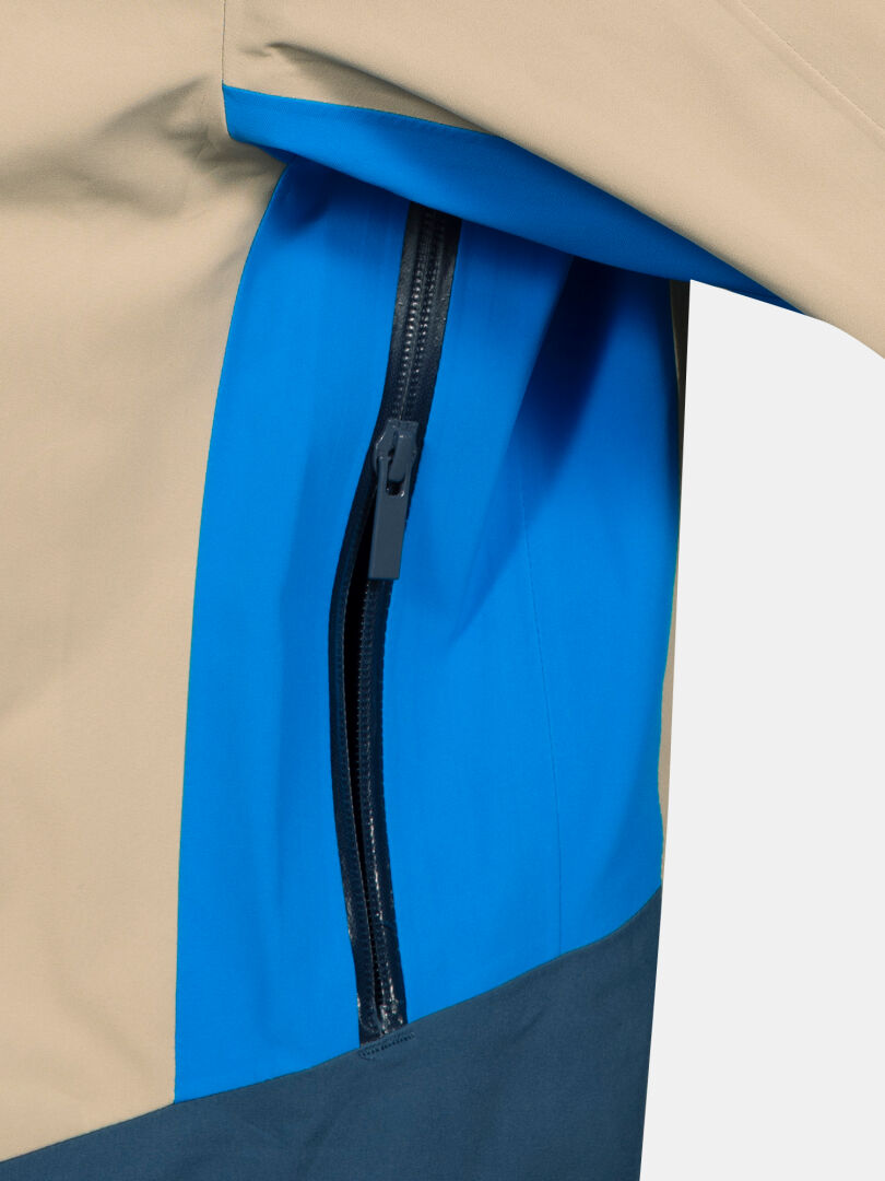 Lähikuva Halti Rizle 3L DX Unisex laskettelutakki beige, sinisen sävyinen Primaloft Thermo fleece ja musta vetoketjutasku.
