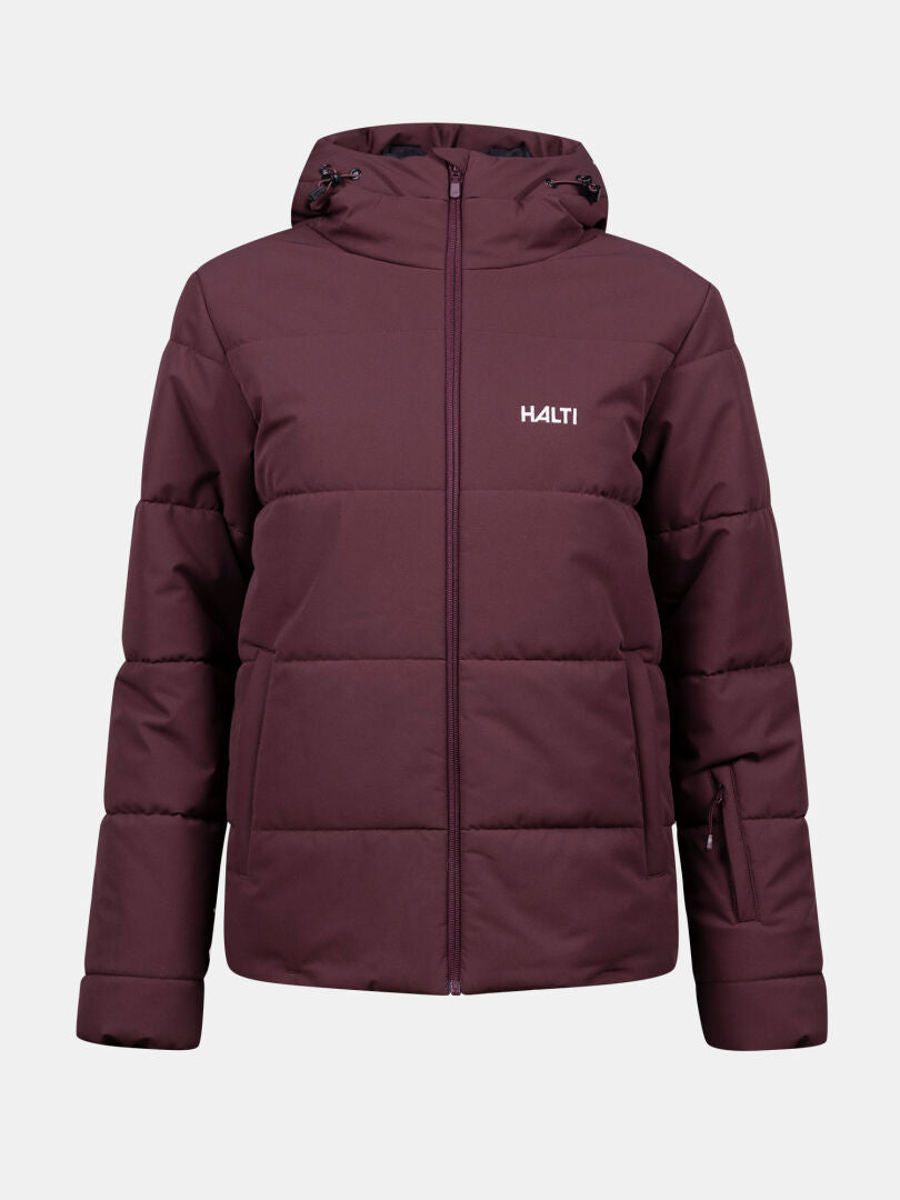 Halti Ascale Puffer Laskettelutakki Naisten Plus on ruskeankeltainen, hupullinen plus-kokoinen takki, jossa on vetoketju ja logo rinnassa.