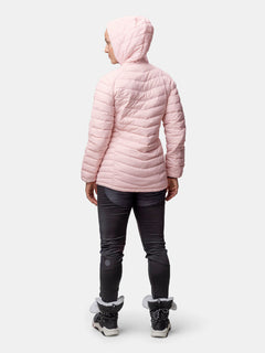 Henkilö seisoo etäällä, yllään Halti Huippu Mid Untuvatakki Naisten, tummat housut ja talvisaappaat.